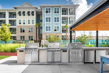 Outdoor kitchen area with refrigerator